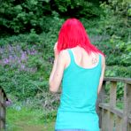 First pic of Slim redhead chick posing in a shirt and skirt outdoors 15 photos