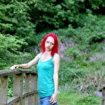 Second pic of Slim redhead chick posing in a shirt and skirt outdoors 15 photos