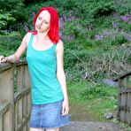 Third pic of Slim redhead chick posing in a shirt and skirt outdoors 15 photos