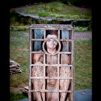 First pic of SexPreviews - Wenona petite brunette is bound in metal cage outdoors and toyed in dungeon