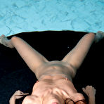 Fourth pic of Dark haired teen Mayuko removes a black bikini to go nude in a pool