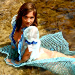Third pic of Adorable young girl Lisa models nude on fisherman's net in shallow water