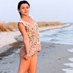 First pic of Brunette teen gets totally naked on an air mattress while at the beach