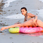 Second pic of Brunette teen gets totally naked on an air mattress while at the beach