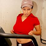 Second pic of Latina chick uncovers her big boobs while exercising on a machine