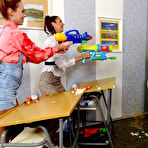 Second pic of Schoolgirls soak their teacher with water guns before getting totally messy