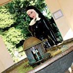 Second pic of Solo model poses indoors and outdoors in latex Mother Superior attire