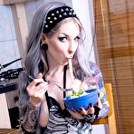 Third pic of Inked female Razor Candi eats her dinner in skeleton apron and goth hosiery