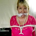 Fourth pic of Mature lady with blonde hair ha her big naturals exposed after being tied up