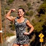 First pic of Bodybuilder Kirsten Klipp Van Arsdale flexes her muscles in a dress on a road