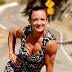 Third pic of Bodybuilder Kirsten Klipp Van Arsdale flexes her muscles in a dress on a road