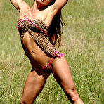 Second pic of Bodybuilder with long red hair Tammi Bingham models lingerie in a field