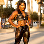 First pic of Black bodybuilder Jaquita Person Taylor flexes outside in black leather attire