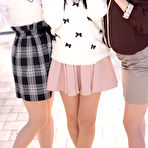 Third pic of Three Japanese girls in skirts pose outdoors for a SFW shoot