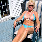 Fourth pic of Mature blonde Ruth frees her tits and ass from a bikini in sunglasses