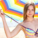 Second pic of Beautiful young girl Dominika gets totally naked under an umbrella on a beach