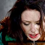 Fourth pic of Clothed brunette Sarah Shevon drips cum from mouth after sex in a dungeon