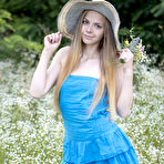 First pic of Petite teen Nastyshka doffs a sun hat and dress to pose nude in a field
