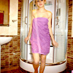 First pic of Blonde teen teases in a shower while wearing a purple bath towel