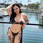 Second pic of Tattooed brunette Brynn Michaels models a bikini at a marina before having sex