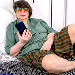 First pic of Fat old woman Sharon Amore gets naked in glasses on top of her bed
