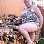 Second pic of Brazen older granny strips off by the wood pile to show off BBW tits & big ass