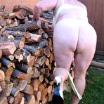 Fourth pic of Brazen older granny strips off by the wood pile to show off BBW tits & big ass