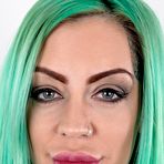 First pic of Tattooed girl with green hair and pierced nipples stands naked after disrobing