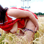 Second pic of Older UK woman Juicey Janey eats berries while getting naked in a crop field
