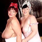Second pic of Mature lesbians show off their large boobs while wearing white nylons