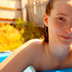 Fourth pic of Natural redhead Julia Fleming frees her big natural tits in above ground pool