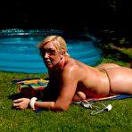 Fourth pic of Fat blonde woman Melody uncups oil laden juggs from bikini in sunglasses