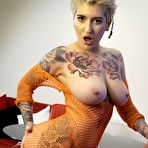 Third pic of Tattooed girl sports short hair while showing her firm tits and trimmed muff