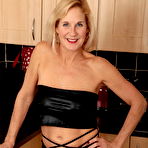 First pic of Older blonde Molly MILF uncovers her big tits in a black miniskirt and heels