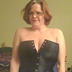 Second pic of Redheaded amateur Misha MILF looses her large tits from a corset in OTK boots