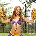 First pic of Ebony cheerleader Verta works her tits and pussy free of her uniform in a yard