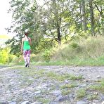 Fourth pic of European female Valentina Ross squats for a pee while strolling a country road