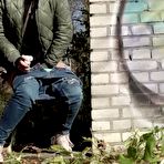 Third pic of Short taken girl pulls down her jeans to take a piss by a brick building
