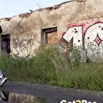 Fourth pic of Petite brunette Natasha squats for a piss in a puddle on a gravel road
