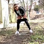 Third pic of Naomi Bennet squats for a badly needed pee on a path behind a building