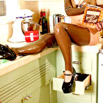 First pic of Kinky girl January Seraph wears rubber attire while cooking in a retro kitchen