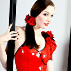 First pic of Tall woman with brunette hair models a latex bodysuit with matching red lips
