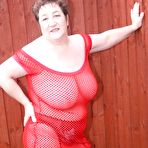 Second pic of Fat amateur Kinky Carol looses her big ass and boobs from a mesh dress outside