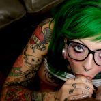 Second pic of Pierced & tattooed Sydnee Vicious wears glasses while giving head