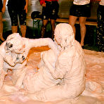 Second pic of Fully clothed fetish lassies enjoy a messy catfight in the mud