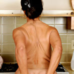 Third pic of Classy mature Persia frees great big tits & flaunts bare feet in the kitchen