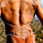 Third pic of Black bodybuilder Stacy Simons flexes during a waterside solo shoot