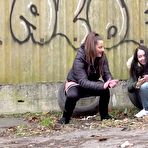 Third pic of Teen girls Nicolette Noir and Mistika squat to piss behind a building