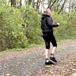 Fourth pic of White girl Grace takes a piss on a stone dust path in the woods