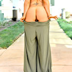 Second pic of Gorgeous girl in yoga pants shows her firm bazookas in the sunshine